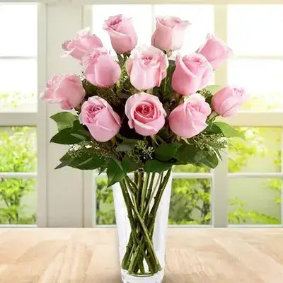 12 Pink Roses with fillers in a Glass Vase