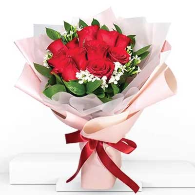 Ravishing Red Roses with Fillers in Pink Paper Wrapping