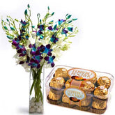 Blue and white orchid flowers in glass vase with ferrero rocher chocolate - for birthday anniversary valentine congratulations good-luck - free urgent delivery India - Delhi Mumbai Bangalore Pune Hyderabad Chennai Kolkata Ahmedabad